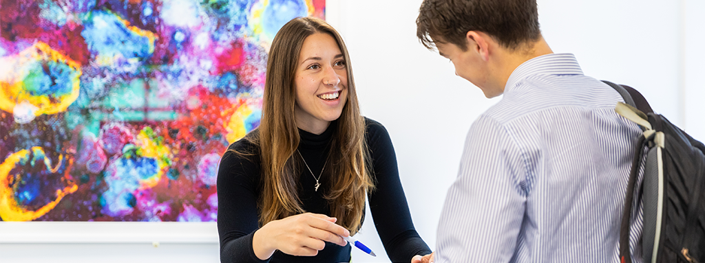 UCD staff member helping student.